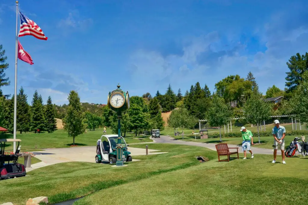 Players on the greens of golf courses, with a kart next to them