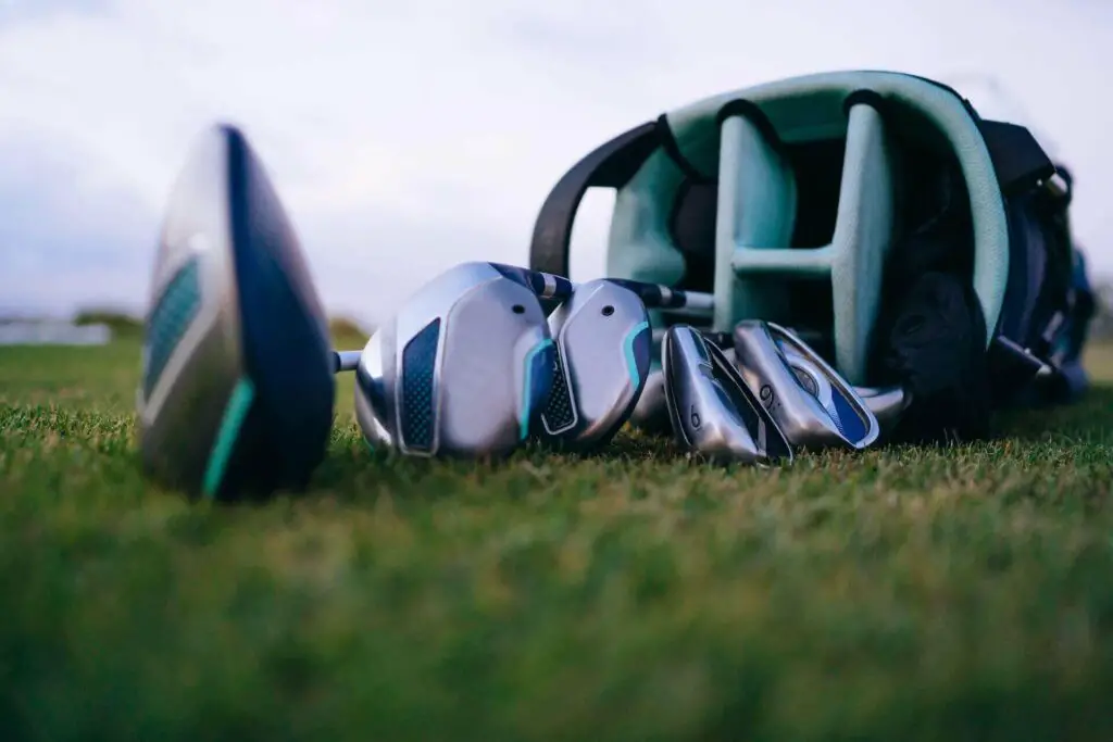 A bag full of golf clubs on grass