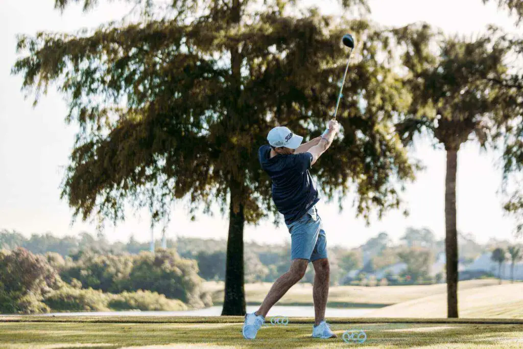  A golfer hitting the ball hard off the tee