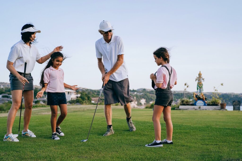 Kids and parents playing golf
