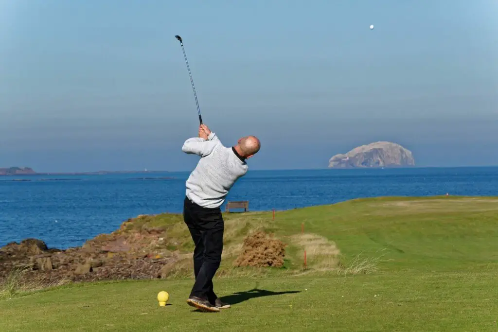 A golfer taking a shot on the course