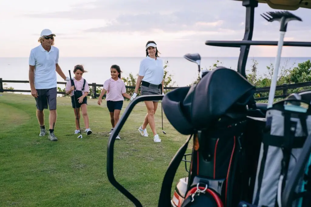 A family of four golfing together