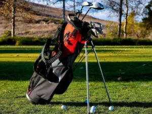 A stand bag on legs, full of clubs