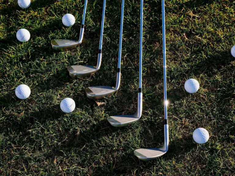 A row of golf clubs and balls