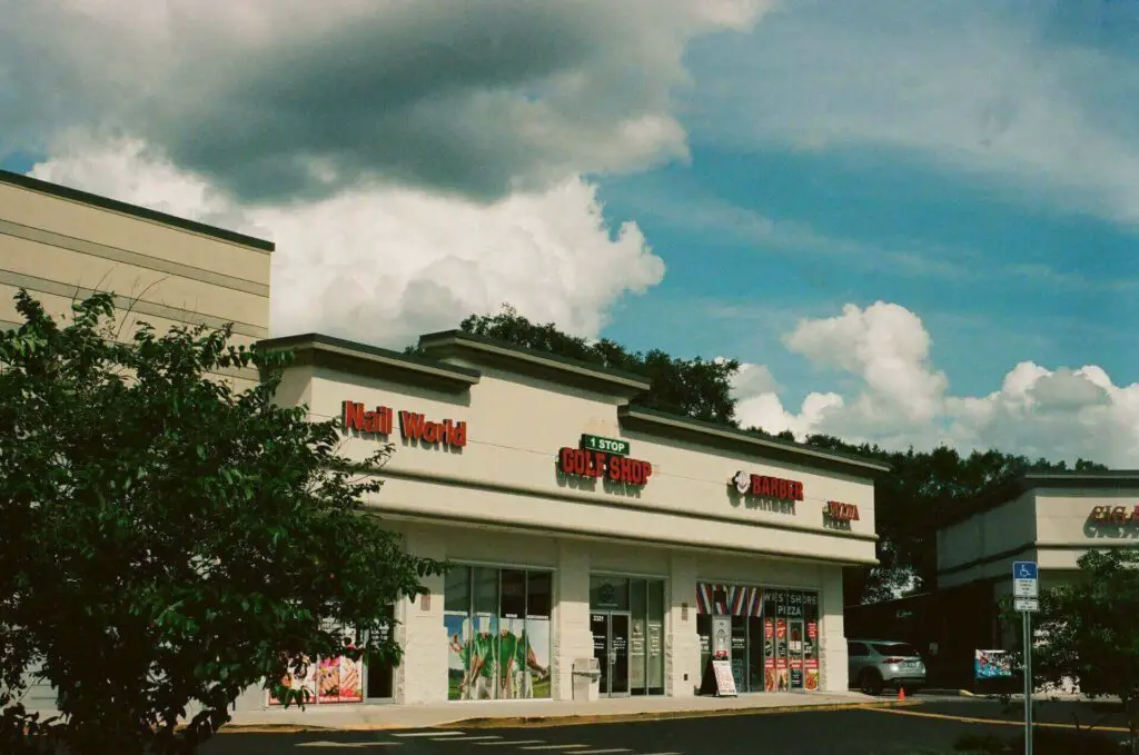 A golf shop in a small building next to other shops