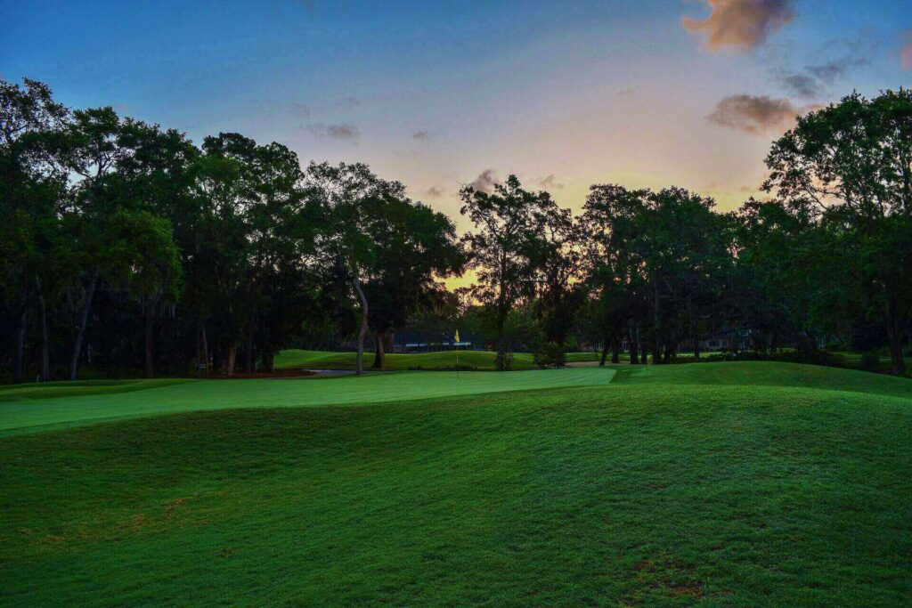 A golfing fairway in the sunset