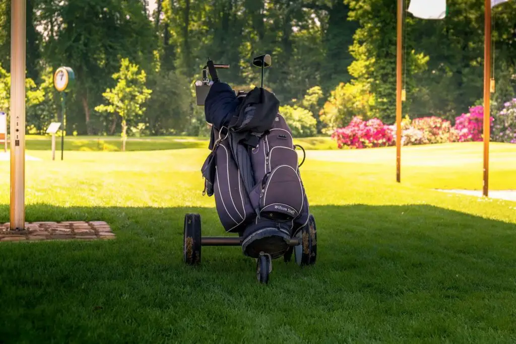 A big golf bag mounted on a push cart
