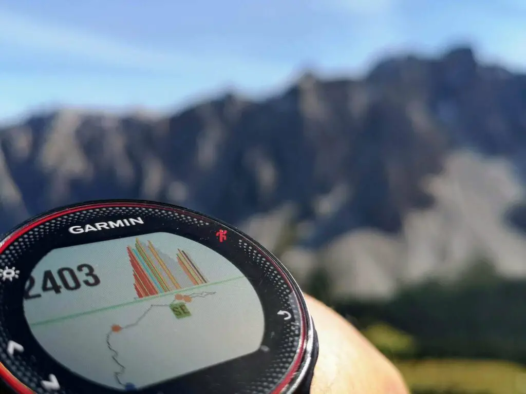 A close-up of a Garmin smartwatch showing altitude