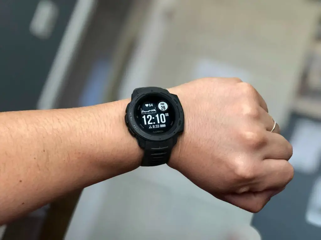 A person looking at their Garmin smartwatch