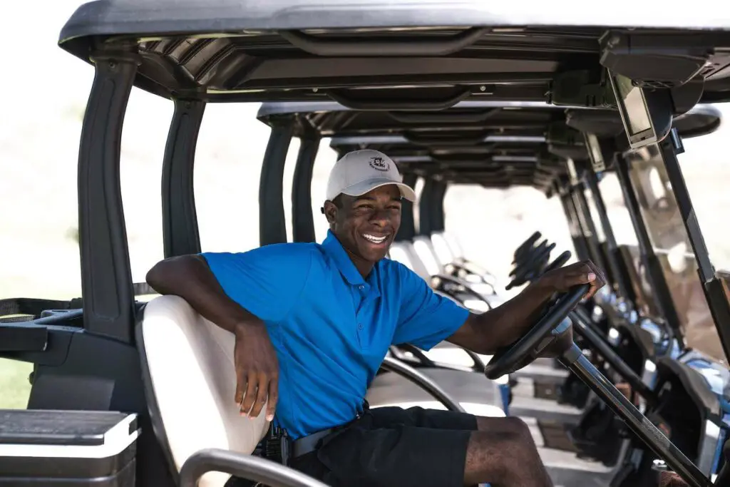 A man smiling while sitting in a cart