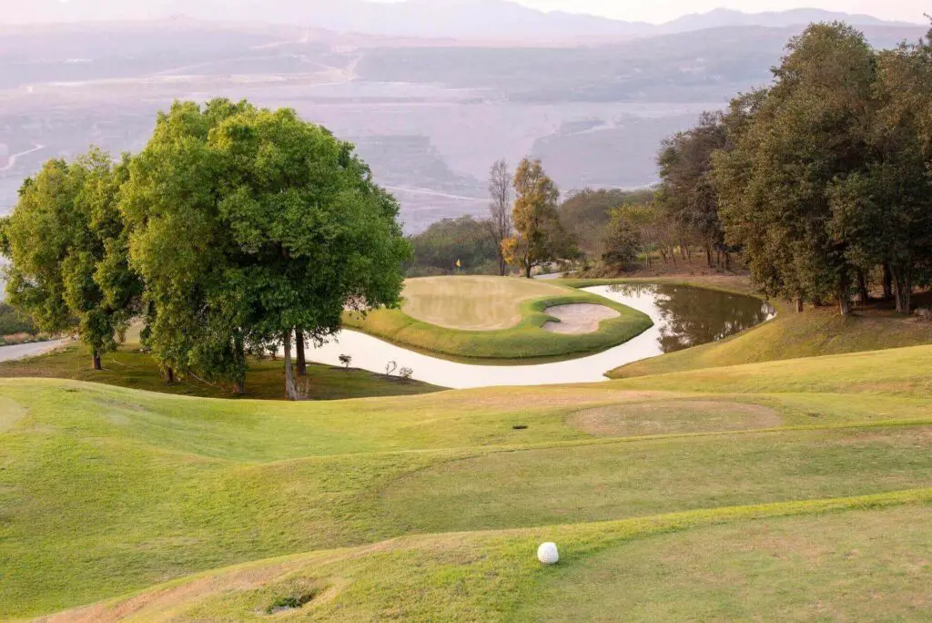 A beautiful course with obstacles and a ball near a hole