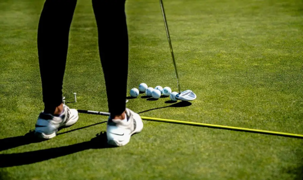 A woman putting multiple golf balls