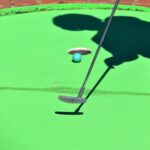 A person playing mini golf