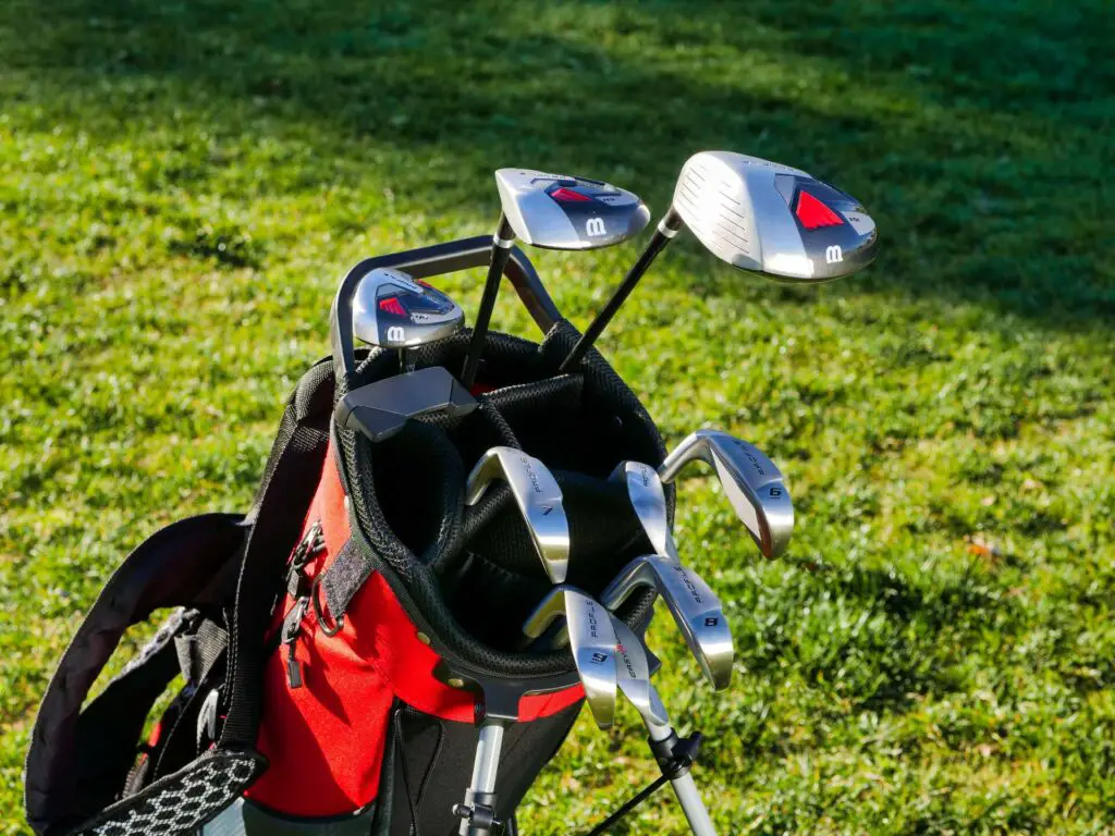 Golf clubs in a red golf bag