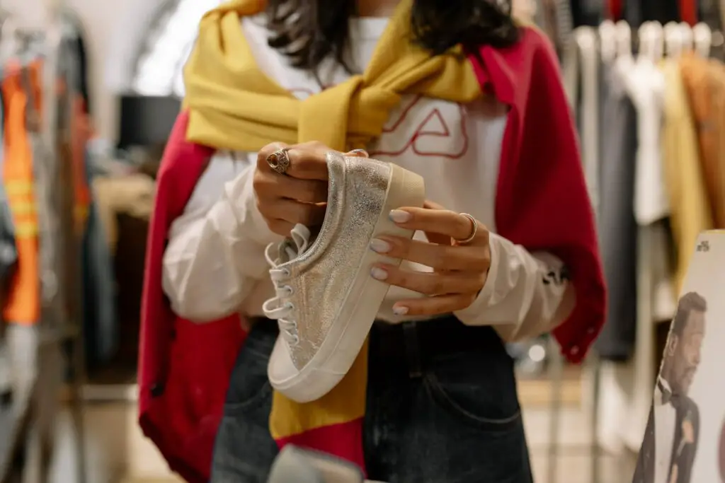 Woman holding a silver sneaker