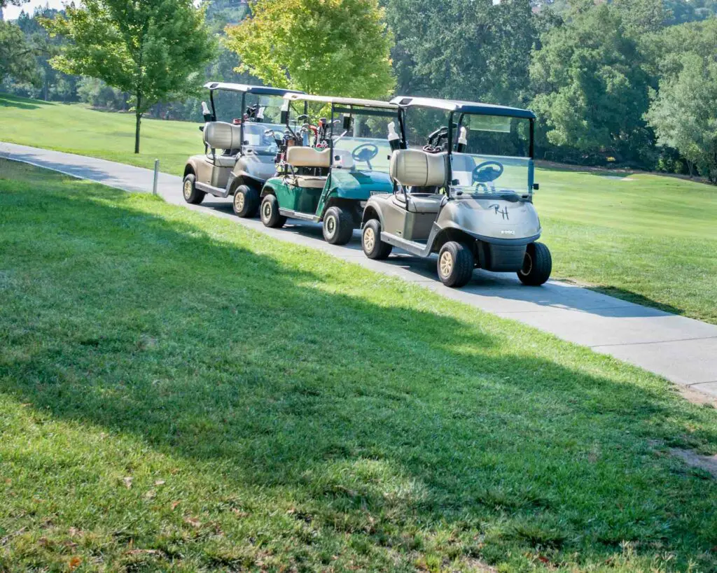 Three golf carts parked tightly together
