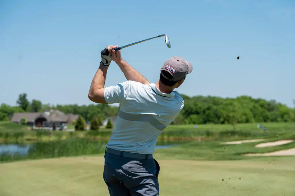 A man playing golf, holding a golf club