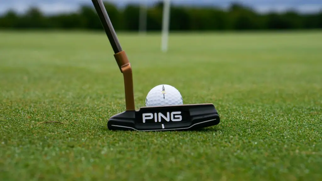 A ping golf putter on a golf course